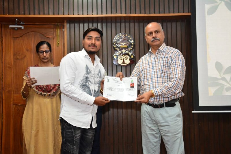Pest management training certificate being handed over
